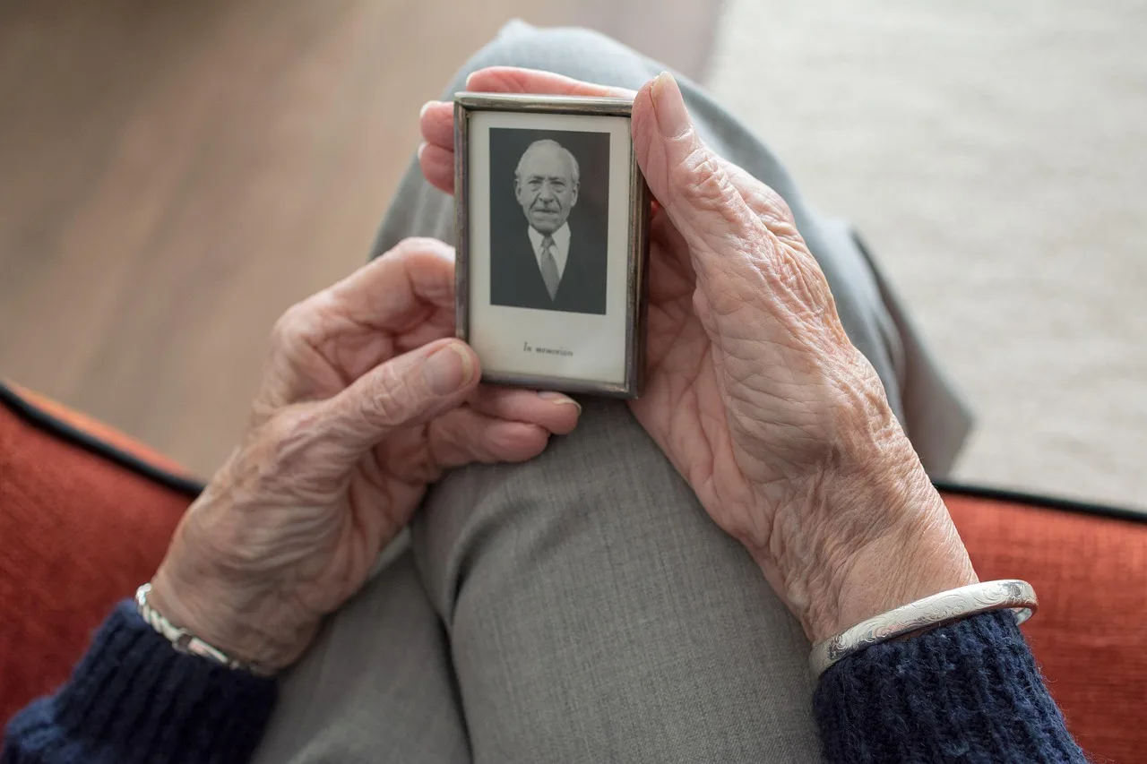 A caregiver assisting a senior with daily tasks in an assisted living environment.