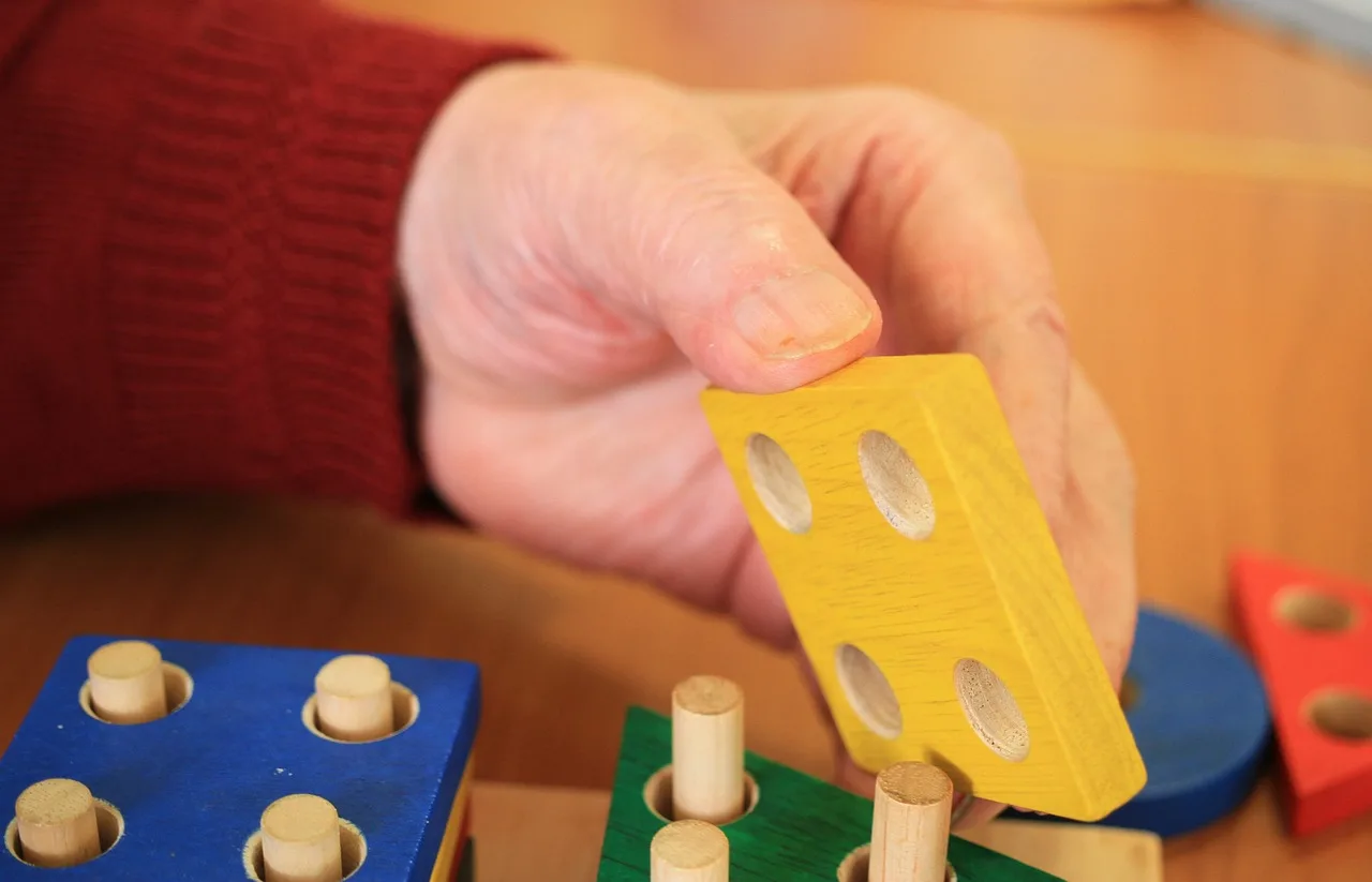 A caregiver assisting a senior with dementia symptoms.